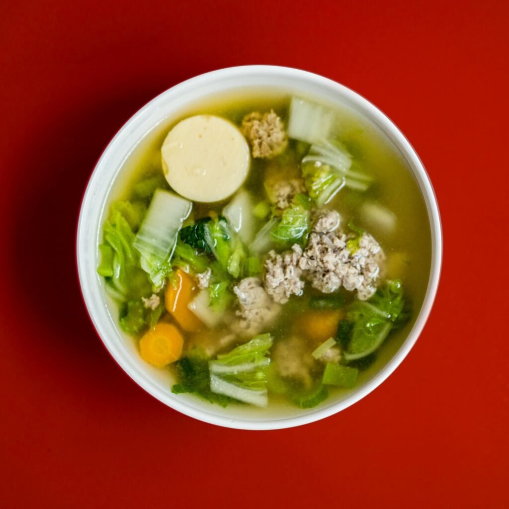 Delicious homemade Asian soup with tofu and vegetables in a vibrant bowl.